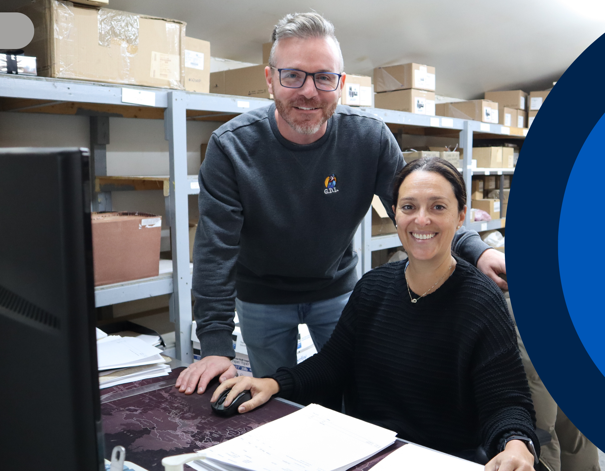 Two people in a warehouse setting, in GDL Equipments office